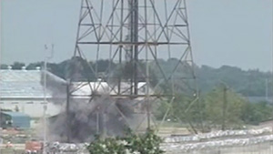 Flare tower destruction displays the demolition project removing the 400-foot, 21-ton flare tower at Newport Chemical Depot, Indiana, on Aug 5, 2003
